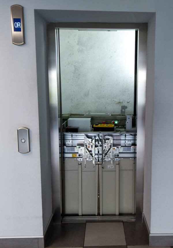 Elevator door open during repair showing the top of the elevator car